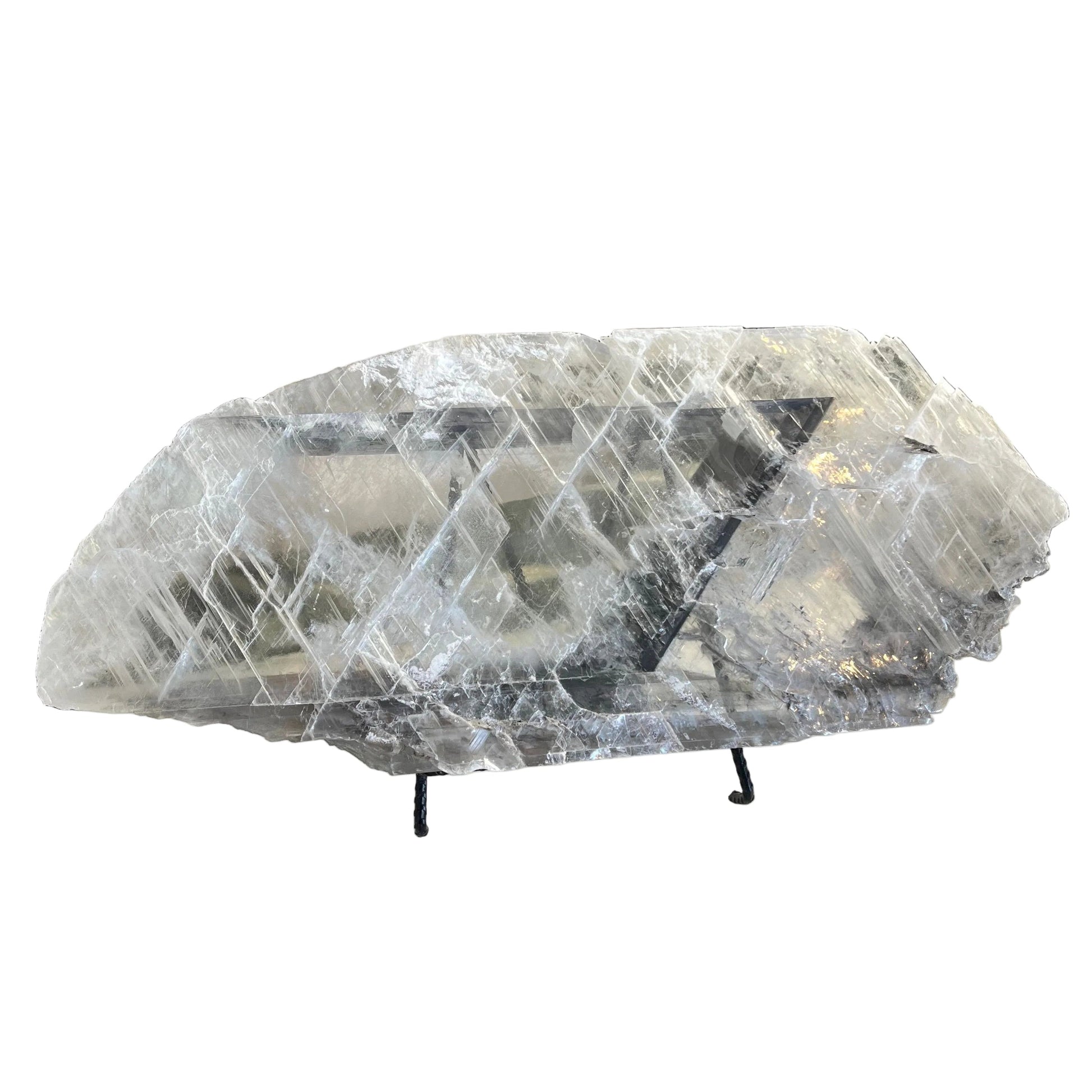 Decorative selenite sculpture on a stand on white background
