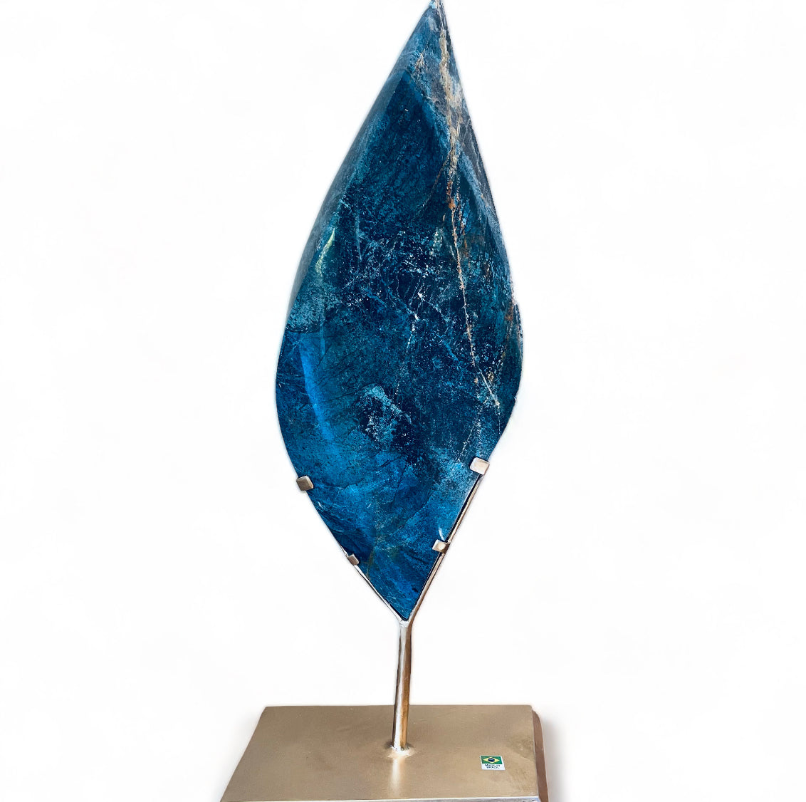 A polished blue Trolleite and Quartz crystal flame on a gold-colored stand.