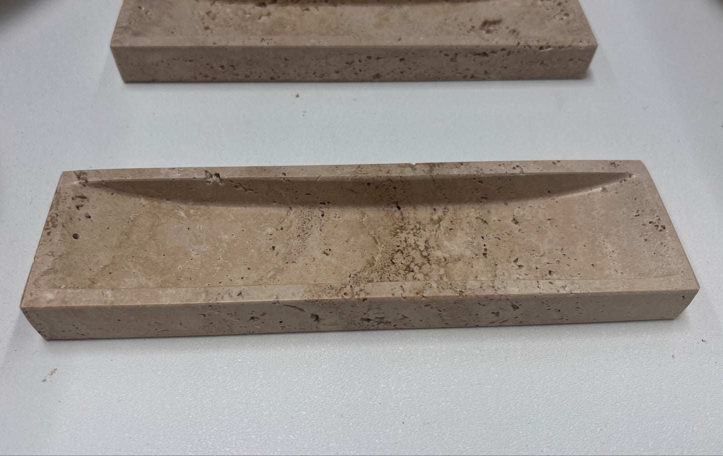 Travertine incense holder carved from natural stone with elongated rectangular form