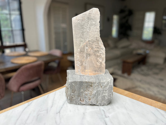 Decorative crystal lamp stone sculpture on a marble surface with a blurred indoor background