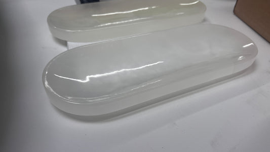 Hand-carved white onyx stone tray with elongated oval shape and polished surface