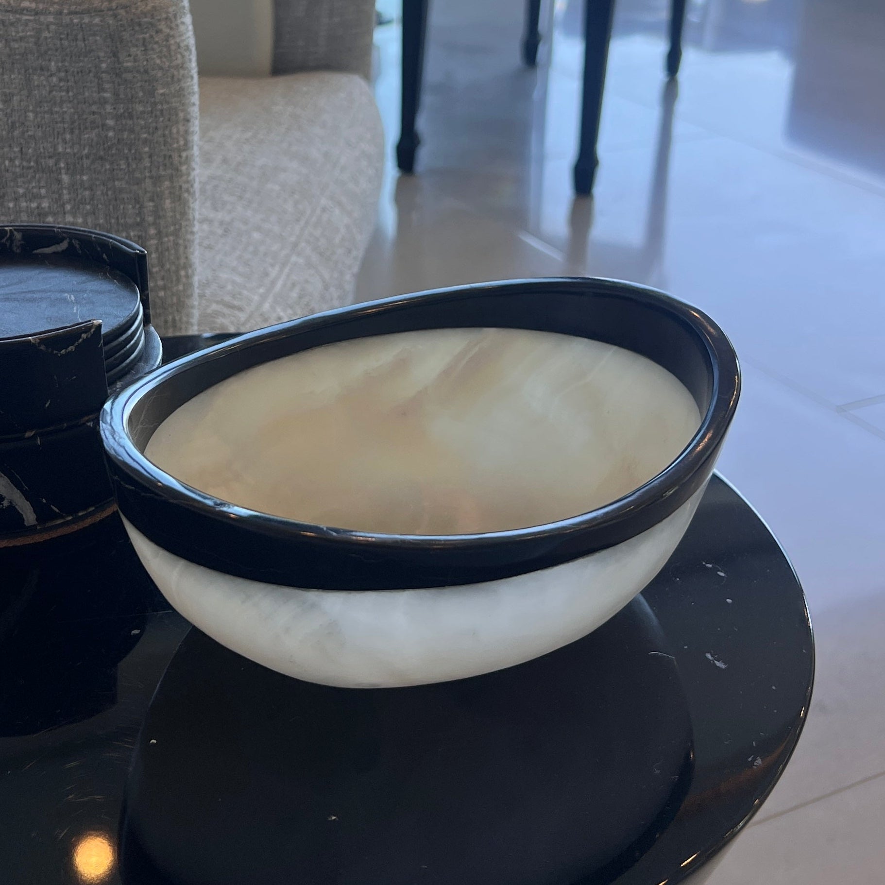 Bowl on a table with a piano and chairs in the background
