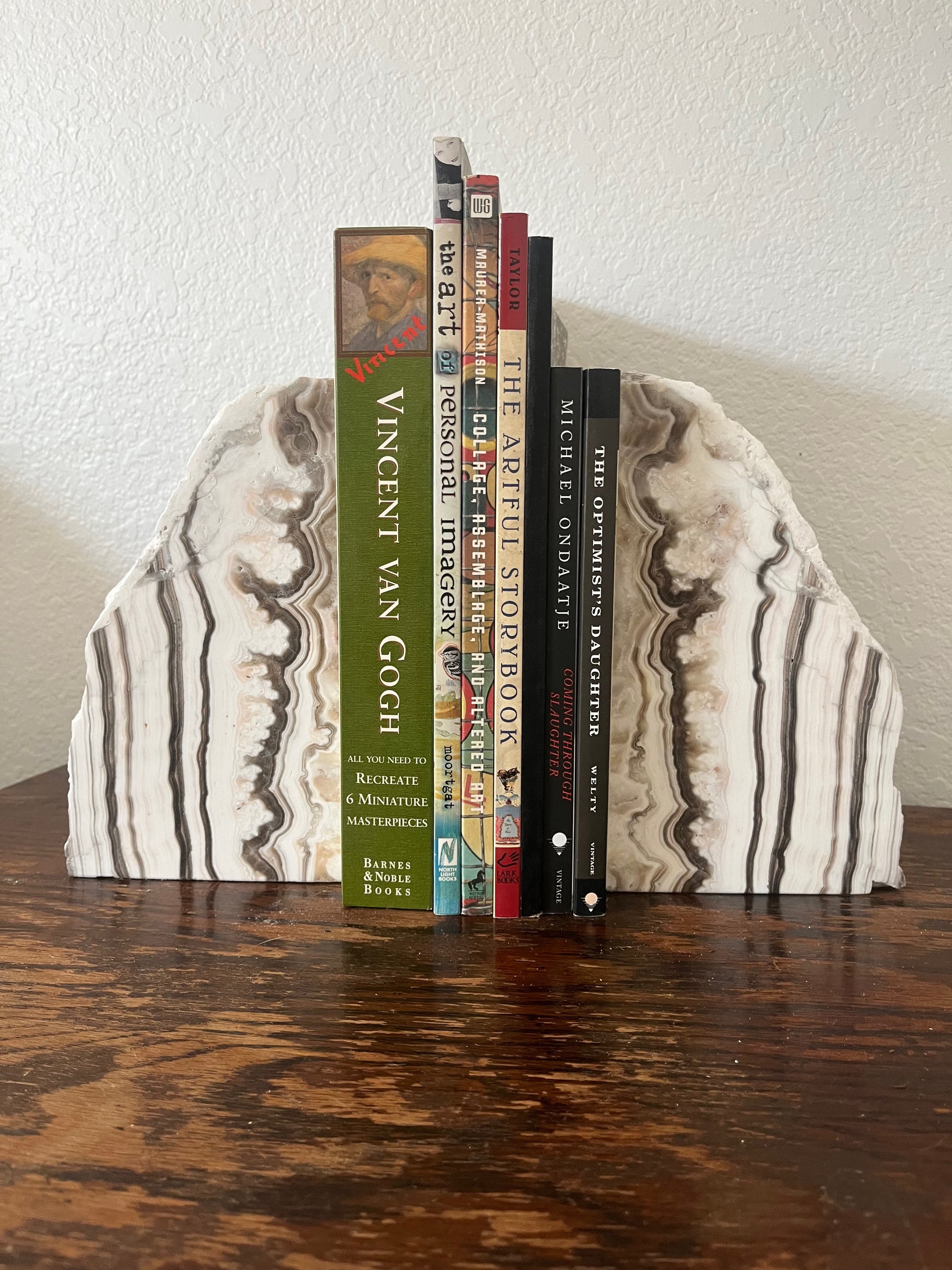 zebra onyx bookends holding books on a wooden surface with a neutral background